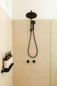 a shower with a black shower head in a bathroom at Spectacular views over Albert Park in Melbourne