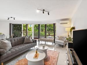 a living room with a couch and a table at Spacious 2 Bed 2 Bath Apartment at South Brisbane in Brisbane