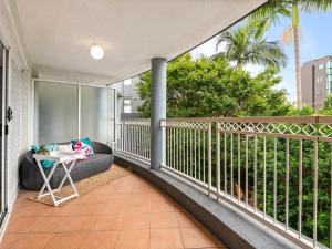 a balcony with a couch and a table at Spacious 2 Bed 2 Bath Apartment at South Brisbane in Brisbane