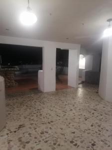 een lege woonkamer met witte muren en een vloer bij Casa con vista y alberca privada in Acapulco