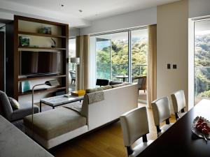 a living room with a couch and a table at OliveBay Hotel in Saikai