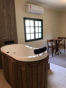 a large bath tub in a living room with a table at Pousada Quinta dos Doges in Valença