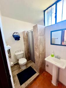 a bathroom with a toilet and a sink at beautiful apartment with the best location in Puerto Vallarta