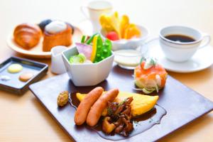 a plate of food on a table with food at The Rise Osaka Kitashinchi in Osaka