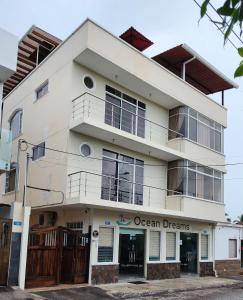 a white building with an ocean dreams sign on it at Ocean Dreams Galapagos in Puerto Ayora