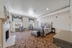 a bedroom with a bed and a fireplace at The Grandeur Estate in Greensburg