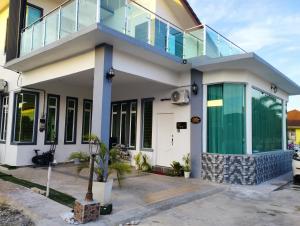 a house with a balcony on top of it at Inap Idaman 4 Near Hospital HUSM Kubang Kerian in Kota Bharu