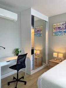 a bedroom with a desk and a bed and a chair at Diamond Resort by I Am Home in Bang Tao Beach