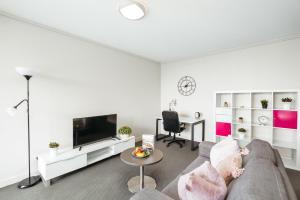 a living room with a couch and a table at Phenomenal City View Central Location 2BD Apart in Brisbane