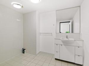 a white bathroom with a sink and a mirror at City Centre Apartment New Furnitures in Brisbane +13 photos