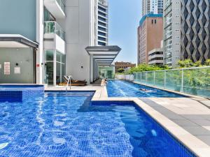 a swimming pool on the roof of a building at City Centre Apartment New Furnitures in Brisbane