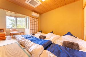 Postel nebo postele na pokoji v ubytování Noёl HAKONE GENSEN