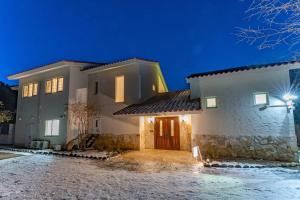 a house with a front door at night at Noёl HAKONE GENSEN in Hakone