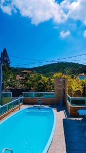 a large swimming pool sitting on top of a house at Sonho 2 Guest House in Búzios