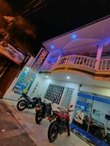 two motorcycles parked in front of a building at Hotel El Paisano in Villavicencio