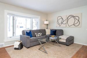 a living room with a couch and a table at NEW Charming Home in the Heart of North Fargo in Fargo