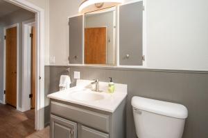 a bathroom with a white sink and a toilet at NEW Charming Home in the Heart of North Fargo in Fargo