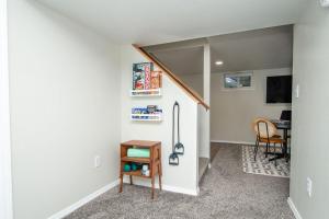 a room with a staircase with a table and a chair at NEW Charming Home in the Heart of North Fargo in Fargo