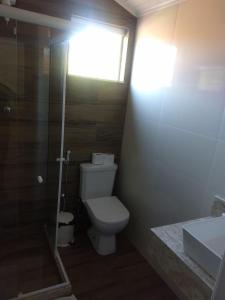 a bathroom with a toilet and a shower and a sink at Sonho 2 Guest House in Búzios