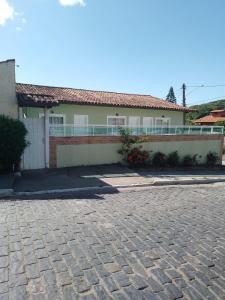 a house with a brick driveway in front of it at Sonho 2 Guest House in Búzios