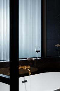 a bathroom with a large window with a sink at Ebb-Dunedin in Dunedin