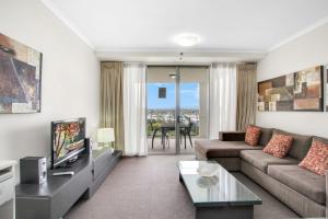 a living room with a couch and a tv at OLD - Welcoming & Comfortable 1BR Retreat in Ipswich