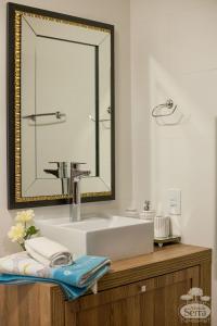 a bathroom with a white sink and a mirror at Casa Holidays - Altos da Serra Catarinense in Bom Jardim da Serra