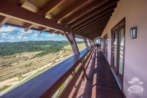 a balcony of a house with a view of the countryside at Casa Holidays - Altos da Serra Catarinense in Bom Jardim da Serra