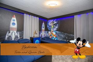 a bedroom with a mickey mouse bedroom and ocean bed at StarWars Game Room 9Bd5BA Sleep 25 ChampionsGate in Kissimmee