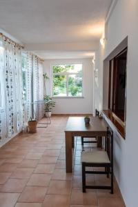 a dining room with a table and a window at Apartments Zeljka B in Mundanije