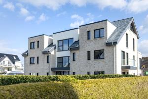 an exterior view of a large brick building at Sturmfrei Suite 4 in Scharbeutz