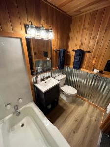 a bathroom with a tub and a toilet and a sink at Three Bears Lodge in Red River
