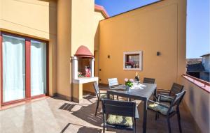 a patio with a table and chairs on a balcony at Lovely Home In Pieve Di Soligo With Wifi in Pieve di Soligo