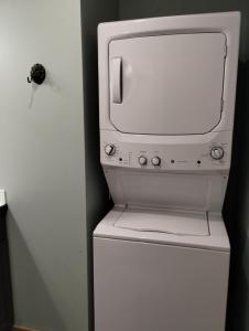 a white microwave sitting on top of a refrigerator at Dockside Cabin - Homer Seaplane Base in Homer