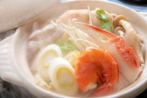 a bowl of soup with seafood and noodles at Tsukasa Ryokan in Saga