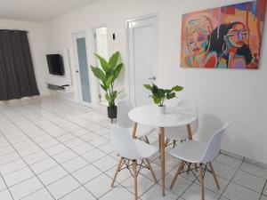 a dining room with a white table and chairs at San Juan Apartments in San Juan +12 photos
