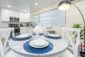 a kitchen with a table with plates and glasses on it at New renovated 2B2B APT Self checkin free parking 1 in Pasadena