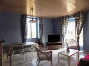a living room with a table and chairs and windows at Appartement Saint-Brevin-les-Pins, 3 pièces, 4 personnes - FR-1-364-47 in Saint-Brevin-les-Pins