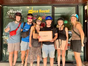 a group of people standing in front of a store at Doze Hostel in Chiang Mai