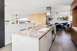 a kitchen with a sink and a counter top at Blue Wave House Modern 3BR in Manhattan Beach in Manhattan Beach