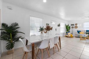 ein Esszimmer mit einem weißen Tisch und weißen Stühlen in der Unterkunft Boho Bungalow - Chic Pet Friendly Mins to Town in St. Augustine + 21 Fotos