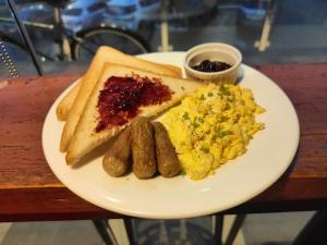een bord ontbijtproducten met eieren, worst en toast bij Go Hotels Butuan in Butuan