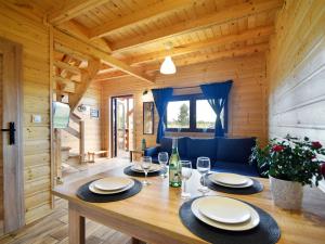 a dining room with a table in a log cabin at Comfortable holiday homes for 7 people, Niechorze in Niechorze