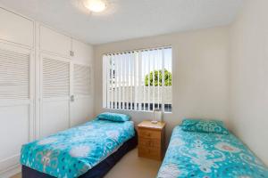 a bedroom with two beds and a window at Kamillaroi Walk to restaurants cafes and beach in Nelson Bay