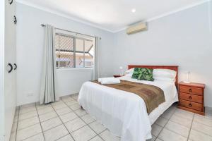 a white bedroom with a large bed and a window at OFFLINE - Charming 3BR Retreat in Central Location of Darwin in Stuart Park