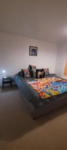 a large bed in a room with at Cozy Comforts 2 bed apartment Central Warrington in Warrington