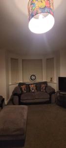 a living room with a couch and a light at Cozy Comforts 2 bed apartment Central Warrington in Warrington