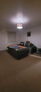 a bedroom with a large bed in a room at Cozy Comforts 2 bed apartment Central Warrington in Warrington