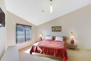 a bedroom with a large bed and a window at Breath Taking Waterfront in Corlette