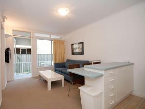 a living room with a couch and a table at Beachside Shoal Bay Unit 6 in Shoal Bay